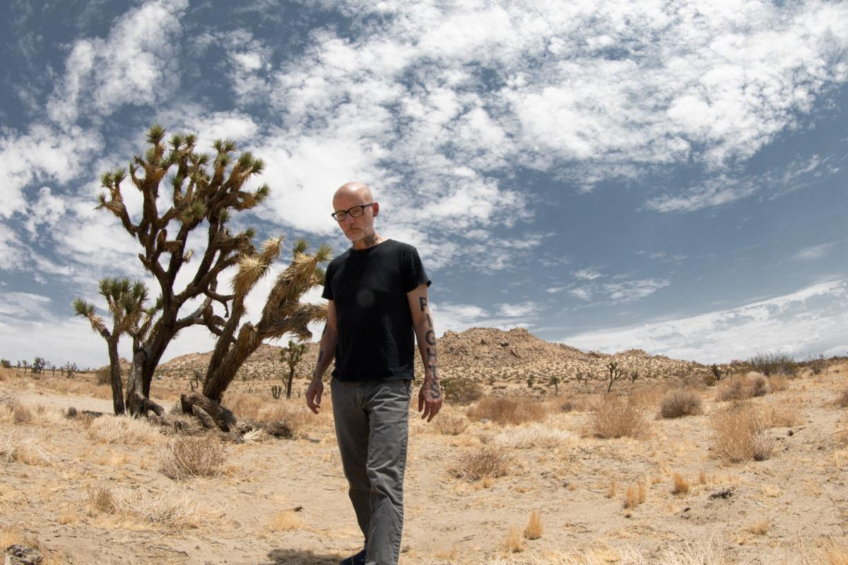Moby walking in desert landscape promotional photo for Future Quiet album