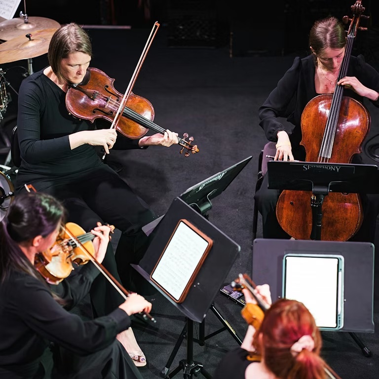 San Francisco Symphony string section musicians performing orchestral concert
