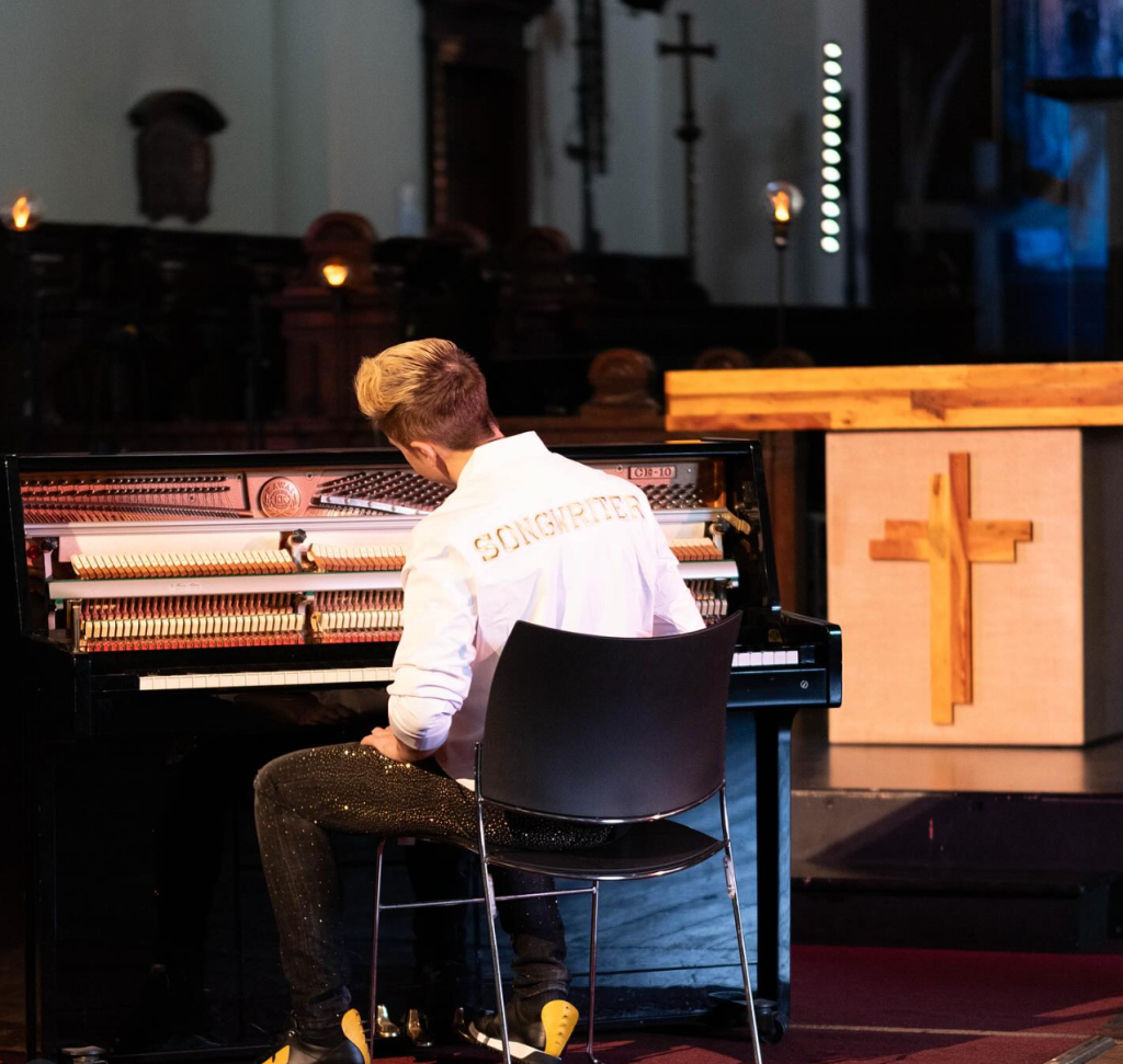 John Galea playing piano in church setting Songwriter performance