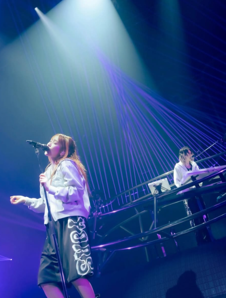 YOASOBI live performance North America tour concert ikura singing Ayase on stage