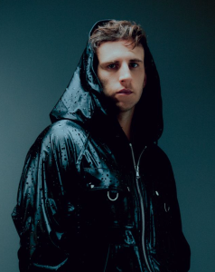 ILLENIUM portrait wearing black hooded jacket electronic music artist