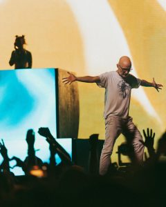 Moby performing live at Coachella 2026 with crowd silhouettes and stage lighting