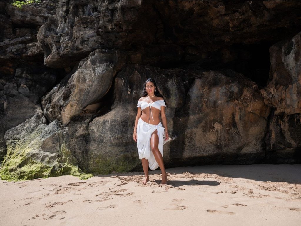 Jessie Reyez N.Y.F.F. single visual on beach wearing white outfit