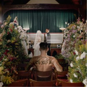 artist wedding funeral scene music video emotional narrative church setting 2026
