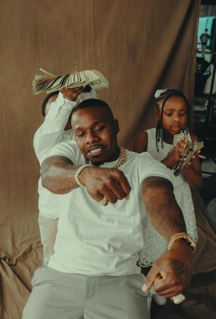 DaBaby with children holding cash in Pop Dat Thang Remix visual scene