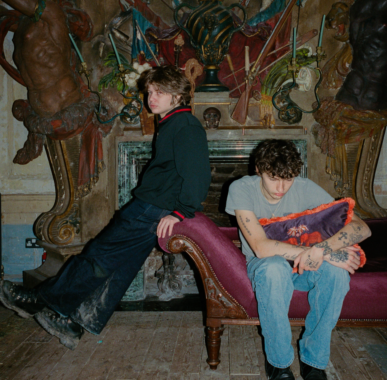 glaive and kurtains seated inside an ornate gothic interior during the God Save The Three album era