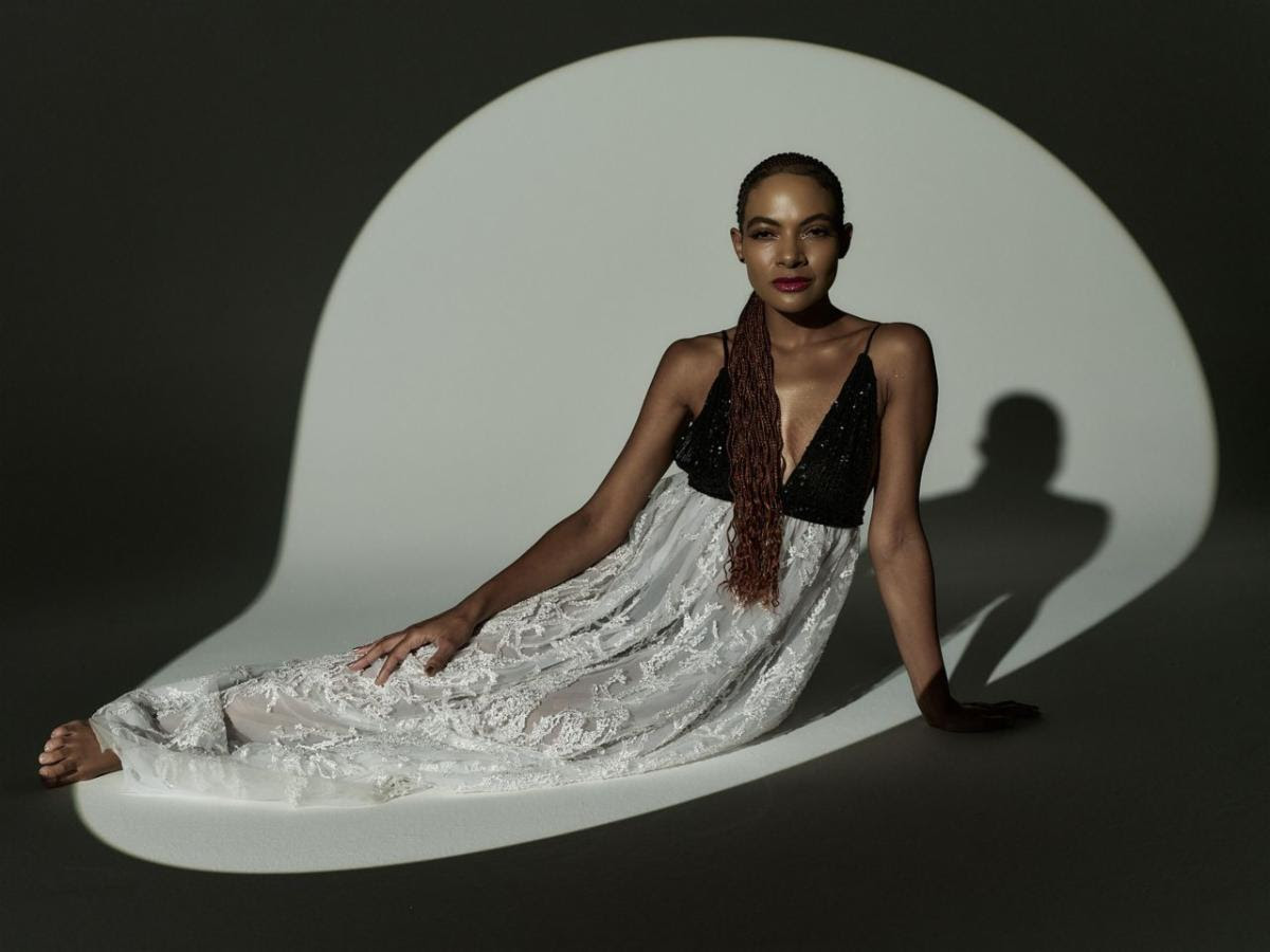 Allison Russell posing in a flowing black and white gown during studio portrait session