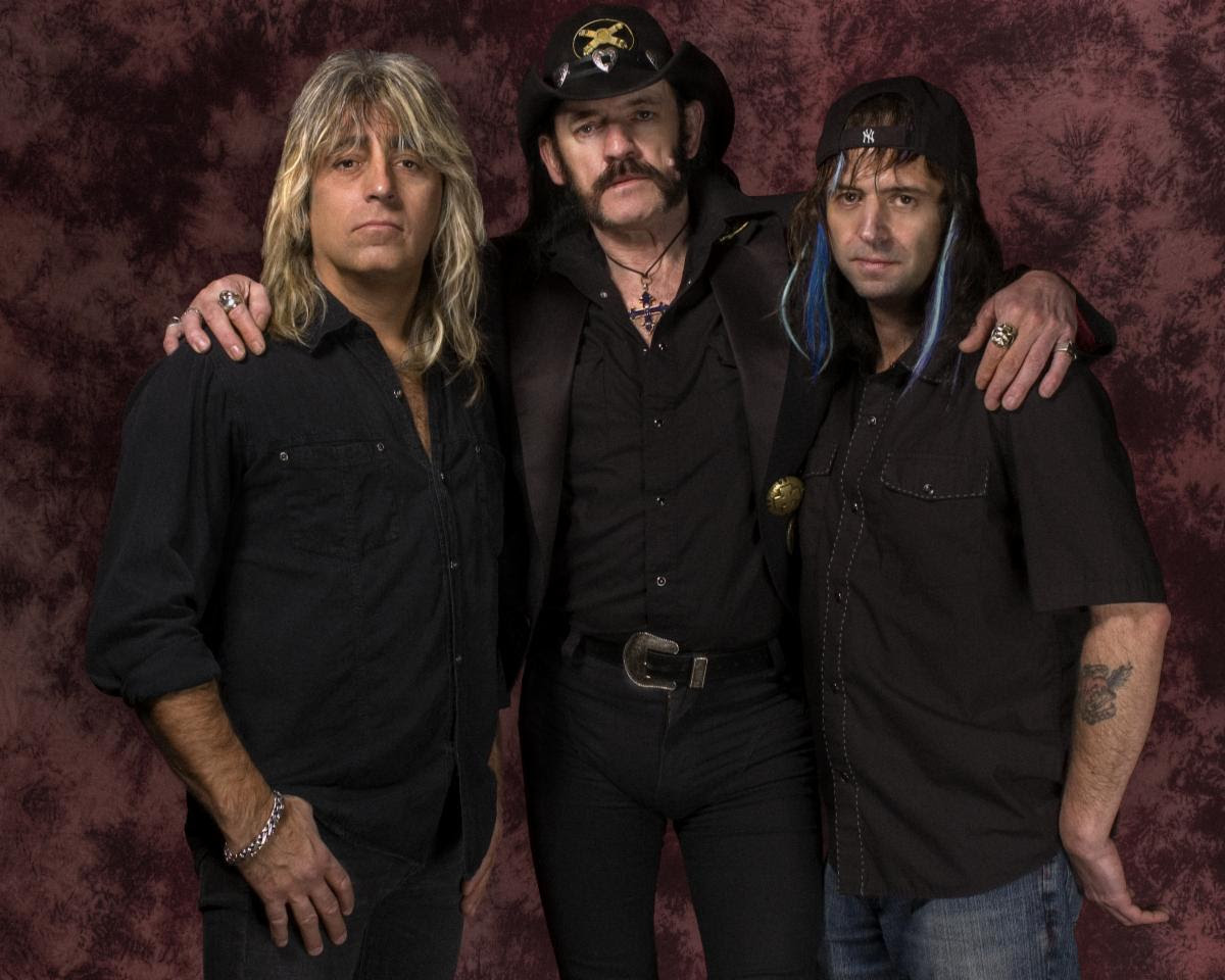 Motörhead members Phil Campbell, Lemmy Kilmister, and Mikkey Dee pose together during the Kiss of Death era in a promotional band portrait.