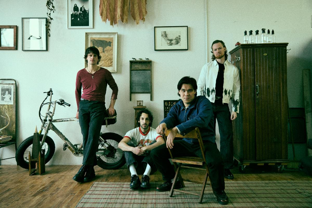 Telescreens band members posed in a vintage styled room with instruments and decor in New York