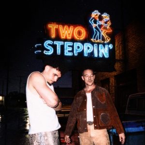 Diplo and Adrien Nunez standing under neon Two Steppin sign promoting new country single