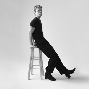 Jamie Hannah black and white studio portrait sitting on stool opera trained singer Oblivion single