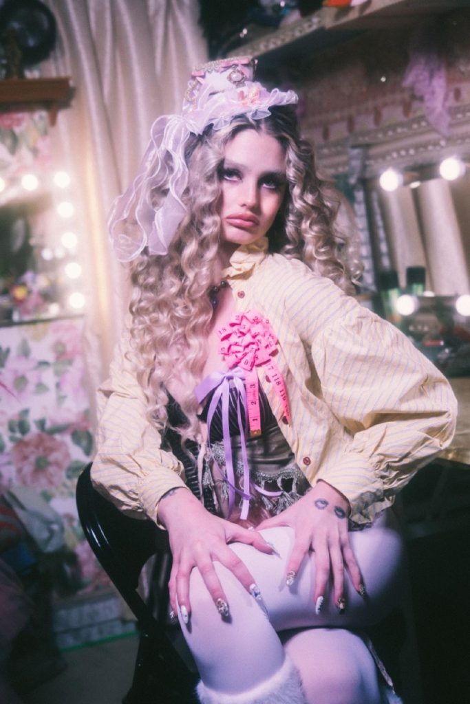 RAEGAN wearing theatrical pageant outfit backstage Angel of Los Angeles visual