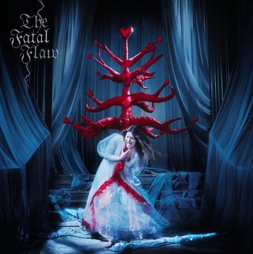 Paris Paloma in ethereal white gown beneath a surreal red heart-shaped structure on The Fatal Flaw album cover