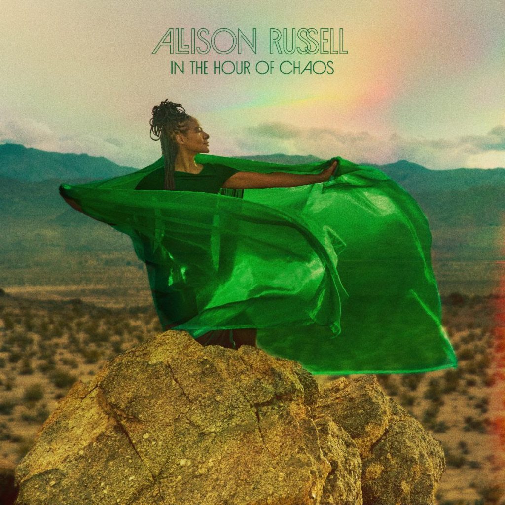 Allison Russell standing on desert rocks wrapped in flowing green fabric for In the Hour of Chaos album artwork