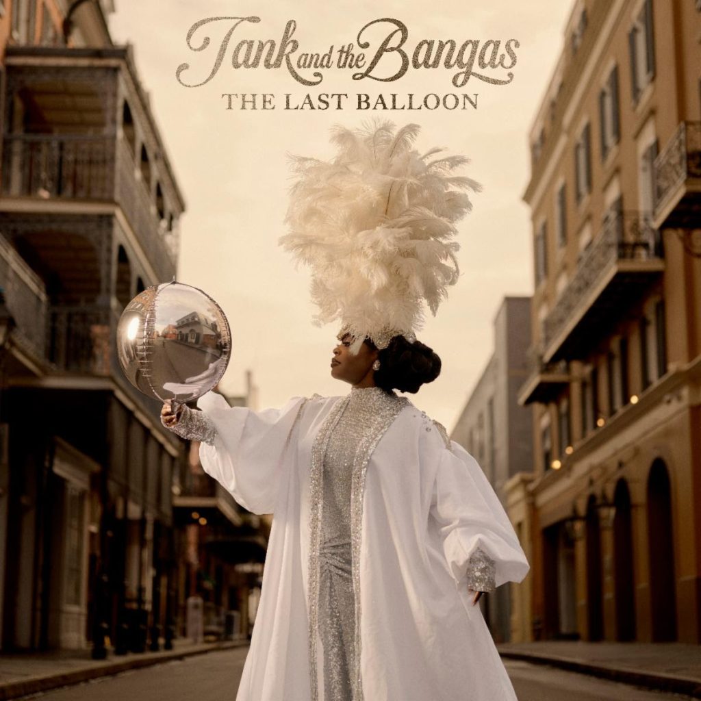 Tank and the Bangas The Last Balloon album cover featuring Tarriona Ball in white ceremonial fashion on a New Orleans street