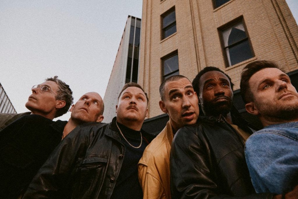 Bleachers band members posing together ahead of Live at The Stone Pony release and 2026 tour