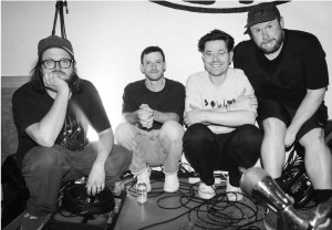PUP band members pose together in a rehearsal space ahead of the release of the "Concrete" music video and new song "If This Is It."