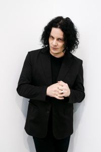 Jack White poses in a black suit in an official portrait promoting his album Frozen Charlotte