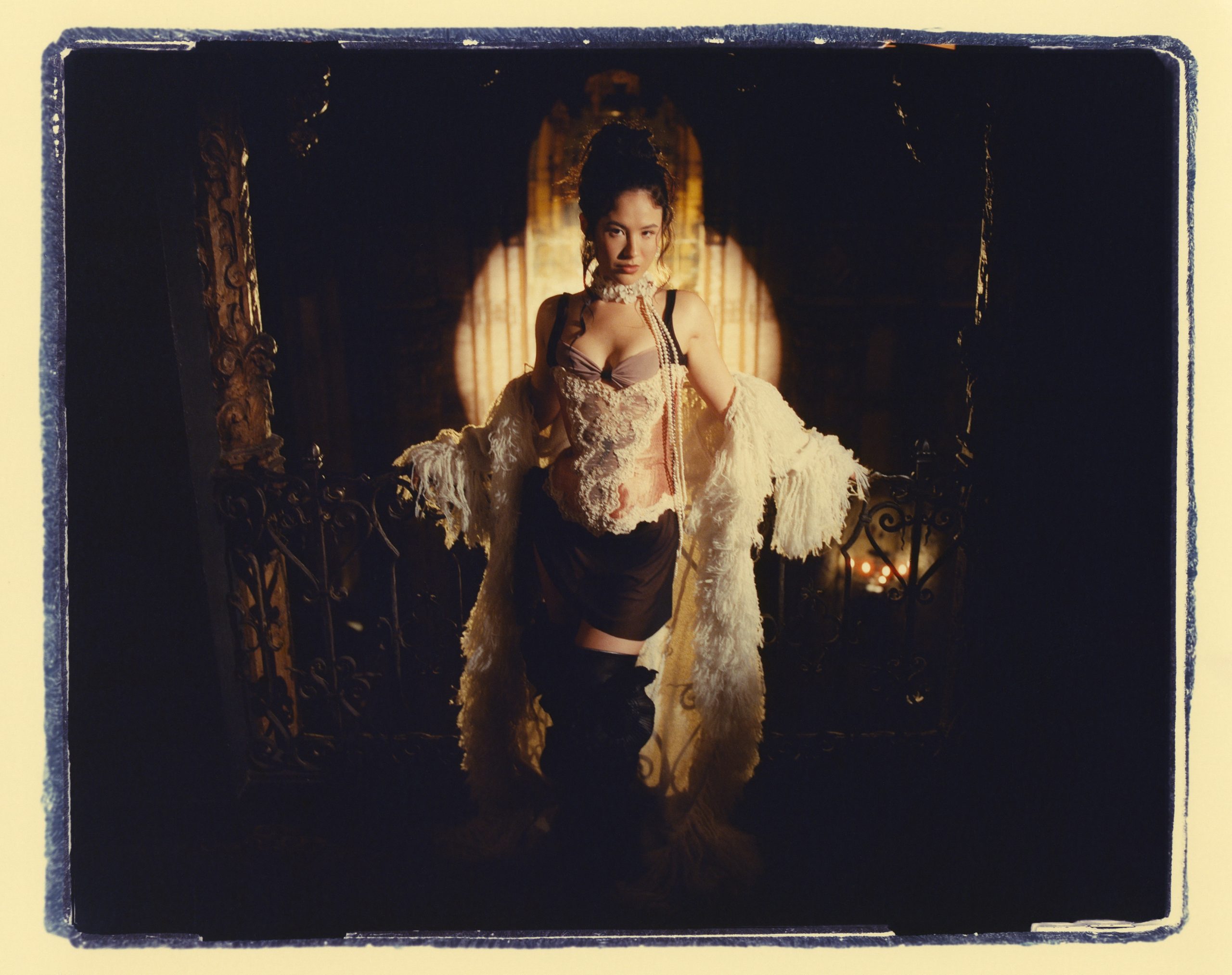 Emei poses in a dramatic opera-inspired setting for her Night At The Opera EP campaign