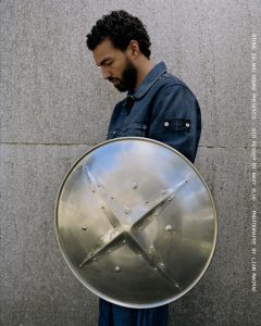 Navy Blue poses with a custom shield created for the Stone Island Sound special edition of Sir Render.