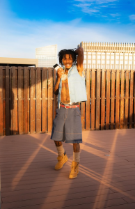 YoungBoy Never Broke Again poses outdoors in a sleeveless denim vest during a 2026 promotional photo for More Leaks 2.
