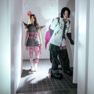 YOASOBI members Ayase and ikura pose in futuristic fashion promoting THE BOOK for, their 2026 album.