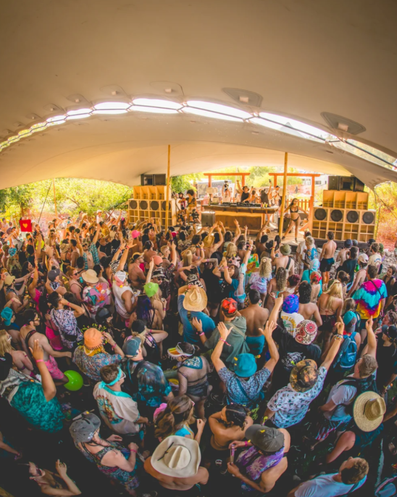 Fans dance beneath a covered stage during Dirtybird Campout x Northern Nights music festival in Northern California.