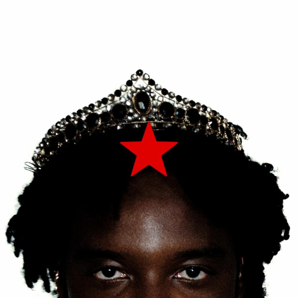 Genesis Owusu wearing a crown to promote his new single "Human Again" following the release of Red Star Wu & The Worldwide Scourge.