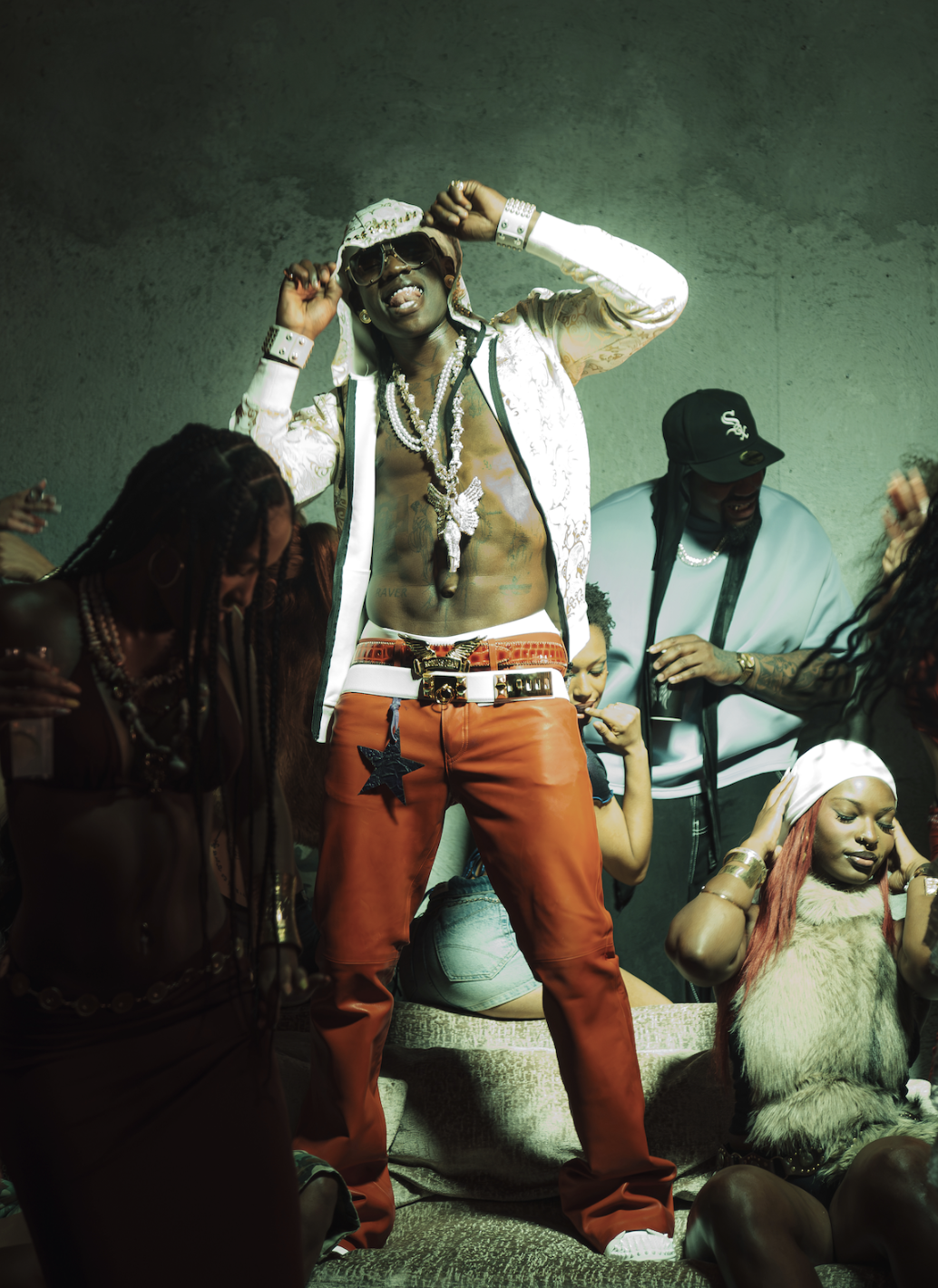 Rema performs surrounded by dancers in a scene from his 2026 “Tea” visual.