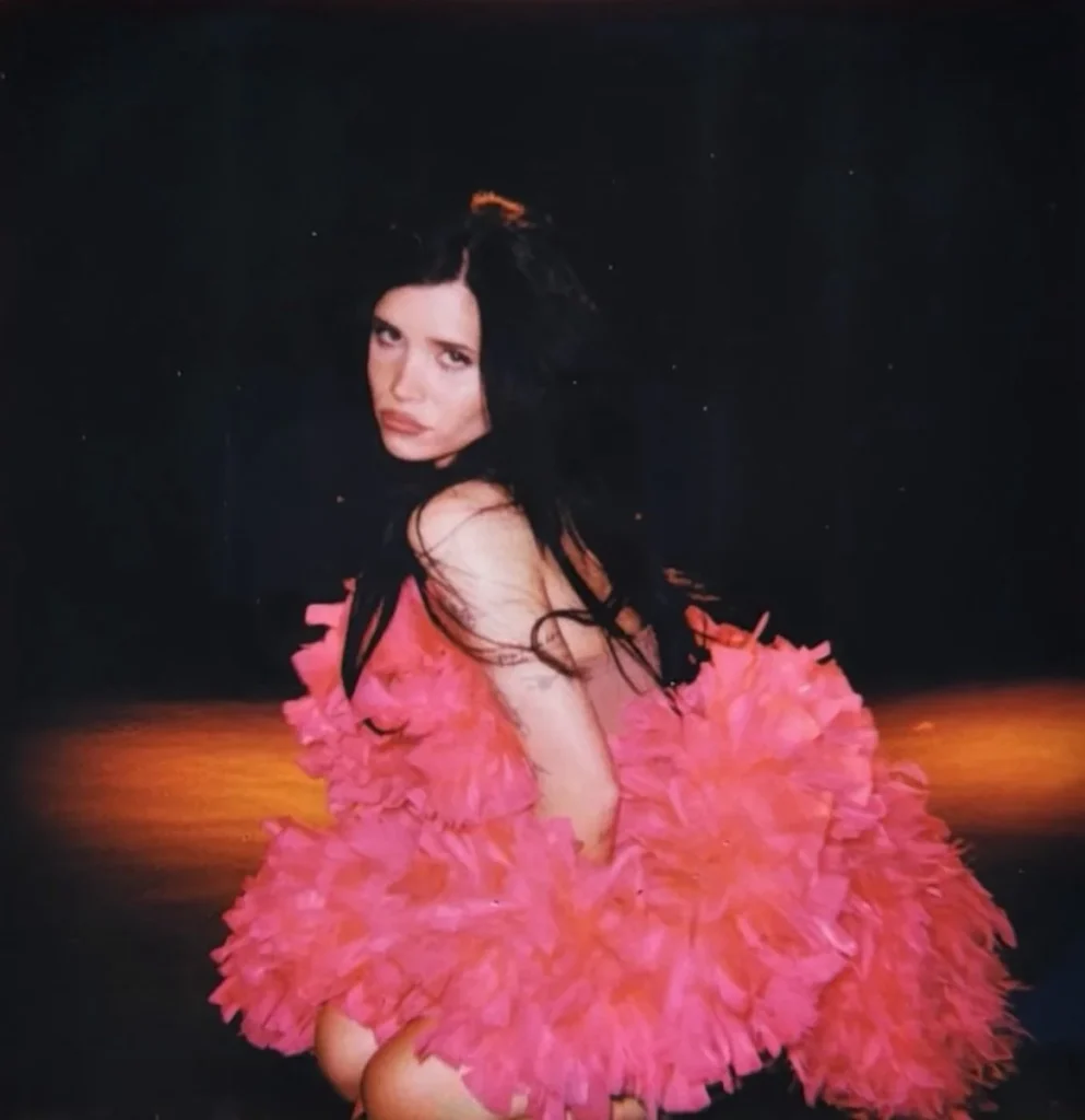 Nessa Barrett wearing a bright pink ruffled dress for “Bad Girls Never Die”