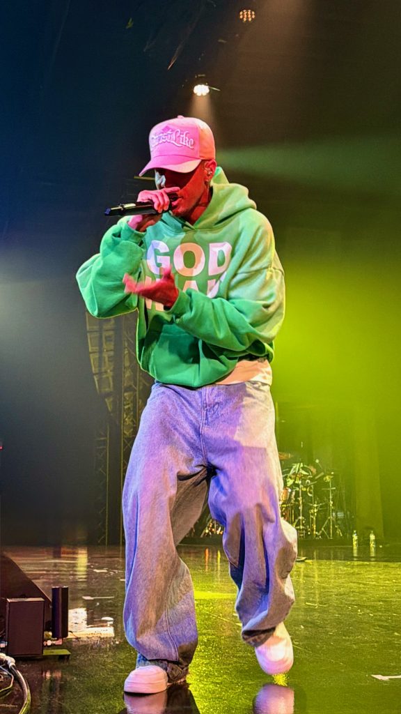 Jon Keith performs beneath green stage lighting during GLO Fest 2026.