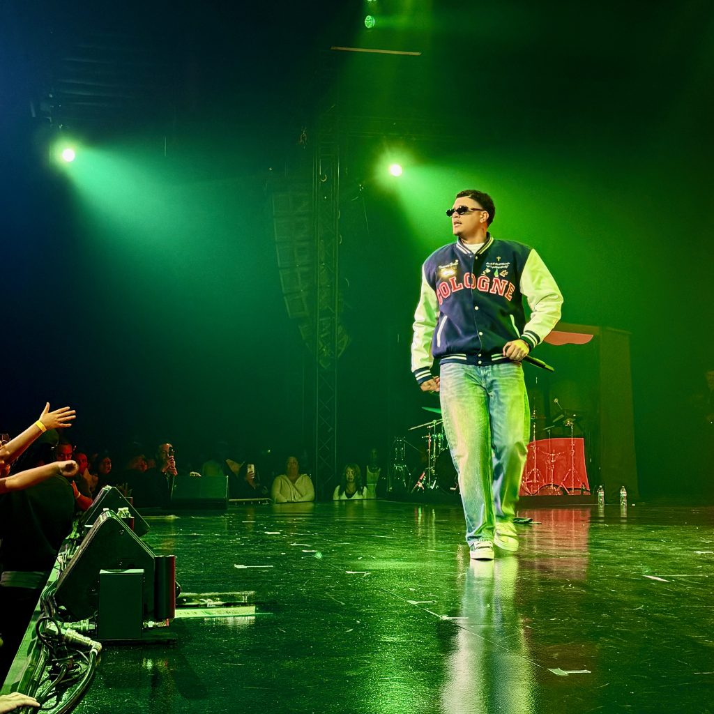 Tommy Zuko performs with a giant 'POWER!' graphic displayed behind him.