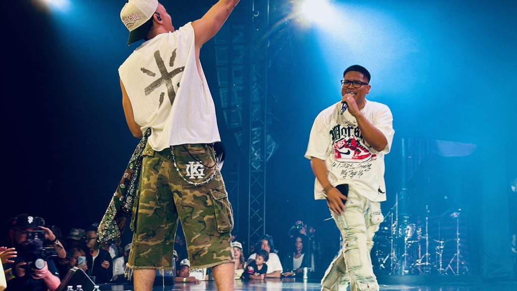 Miles Minnick performs alongside a guest artist during GLO Fest 2026.