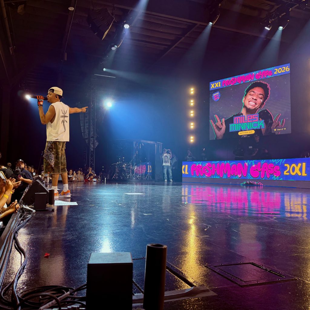 Miles Minnick performs beneath his XXL Freshman Class of 2026 announcement during GLO Fest.