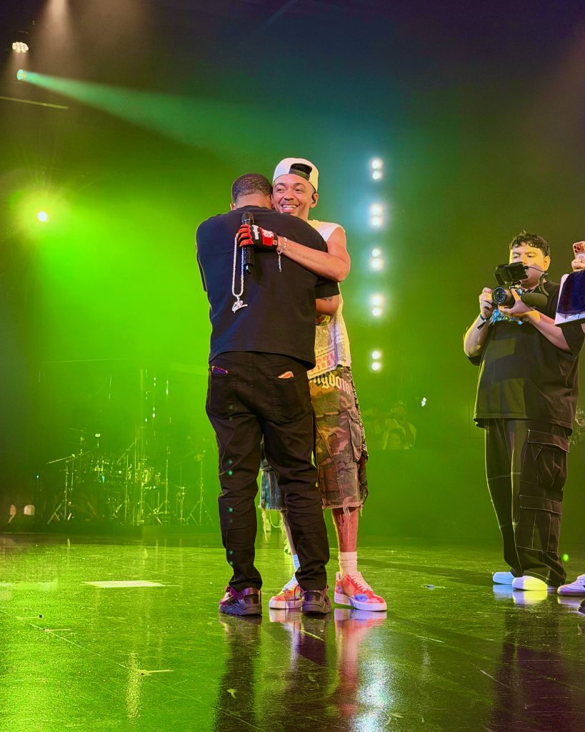Miles Minnick embraces an emotional fan onstage during GLO Fest 2026 in Mountain View, California.