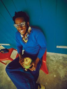 Leon Bridges wearing sunglasses and a blue outfit in a portrait by Joshua Kissi
