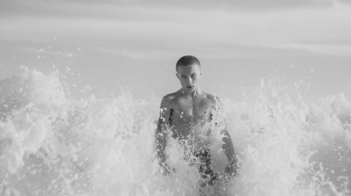 Nettspend standing chest-deep in the ocean in a black-and-white still from “sober”