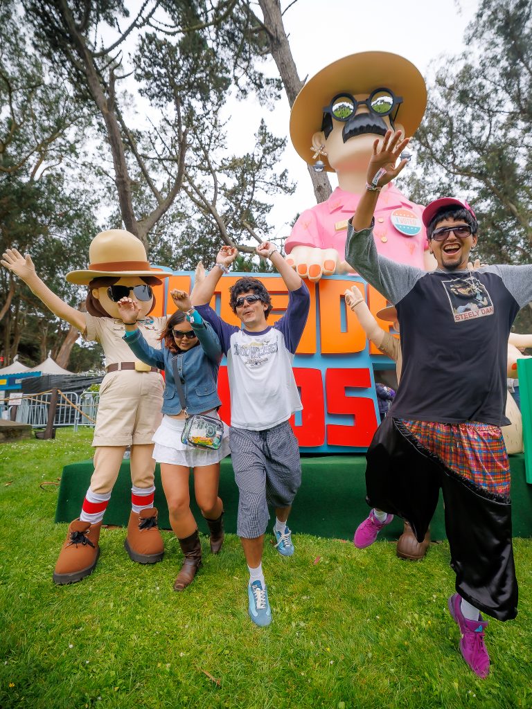 Festivalgoers dancing in front of an Outside Lands installation in Golden Gate Park