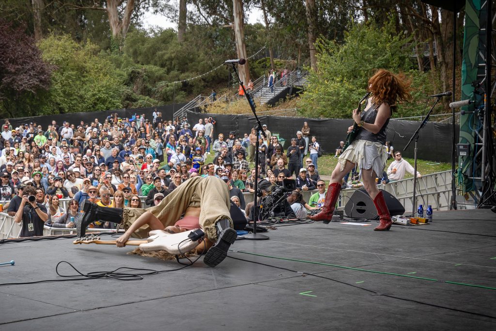 Rock musicians performing for a crowd at Outside Lands 2026 in Golden Gate Park