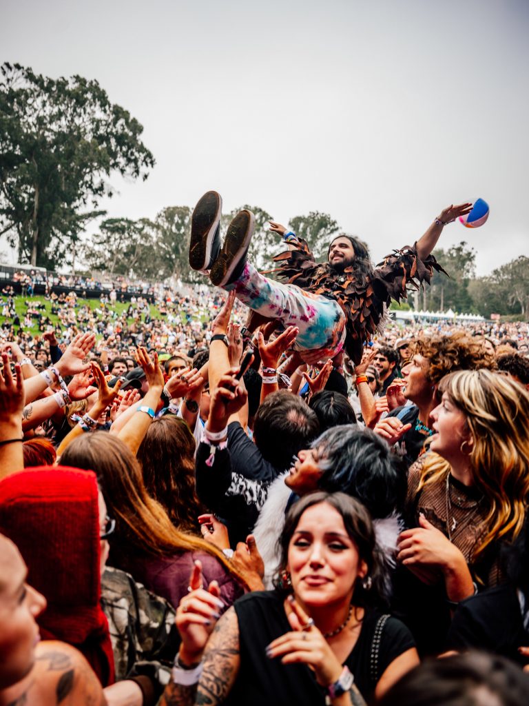 A festivalgoer crowd surfs over a packed audience at Outside Lands 2026 in San Francisco.