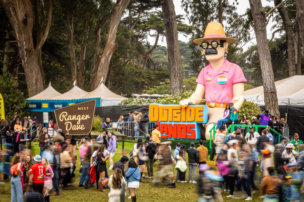 Giant Ranger Dave installation surrounded by festivalgoers at Outside Lands 2026 in Golden Gate Park.