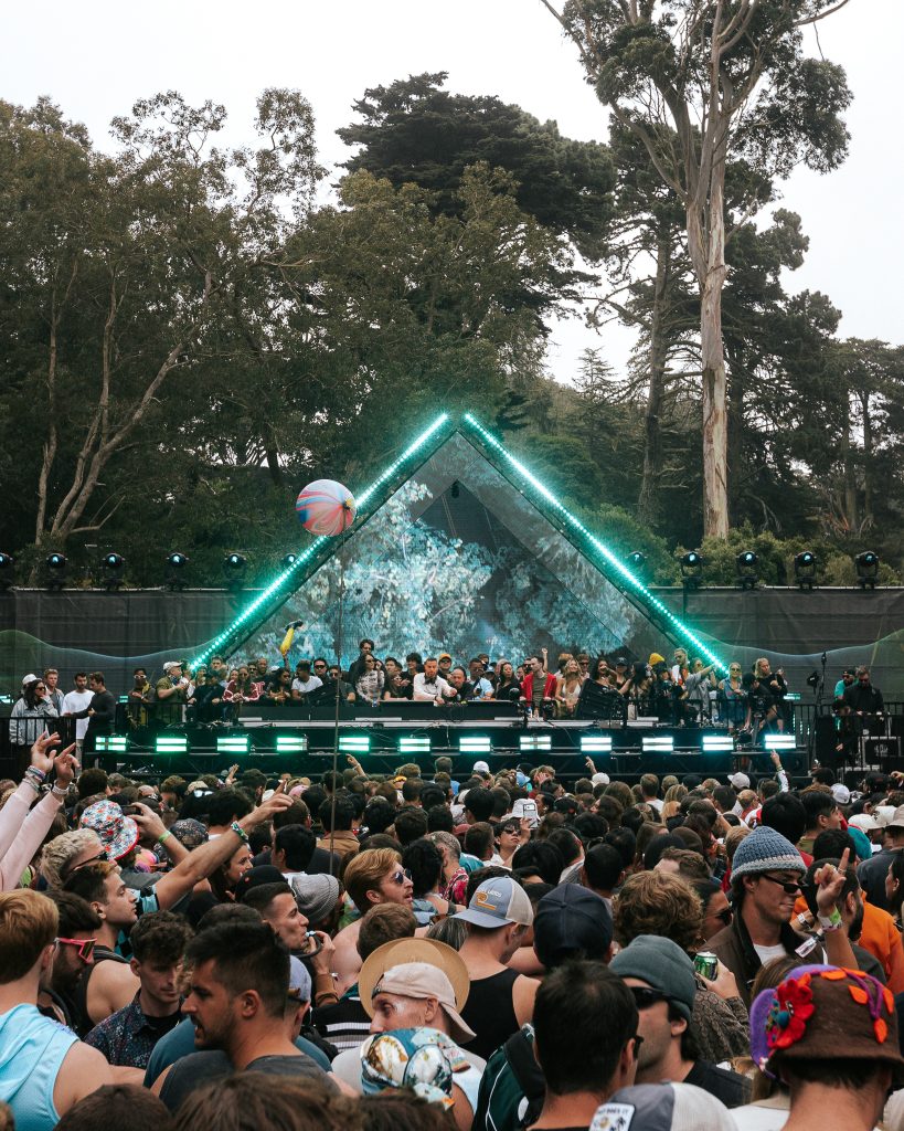 DJs perform behind the decks surrounded by fans at the SOMA Stage during Outside Lands 2026.