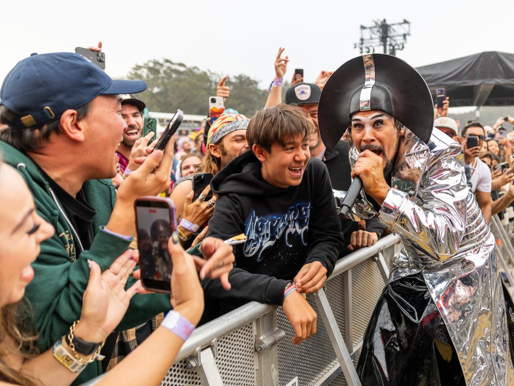 Empire of the Sun performs in a futuristic silver costume among fans at Outside Lands 2026 in San Francisco.