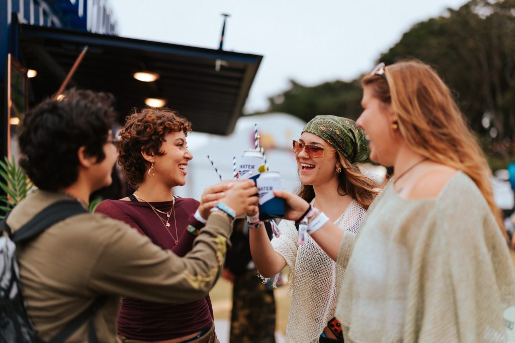 Friends toast drinks together at Outside Lands 2026 in San Francisco’s Golden Gate Park.