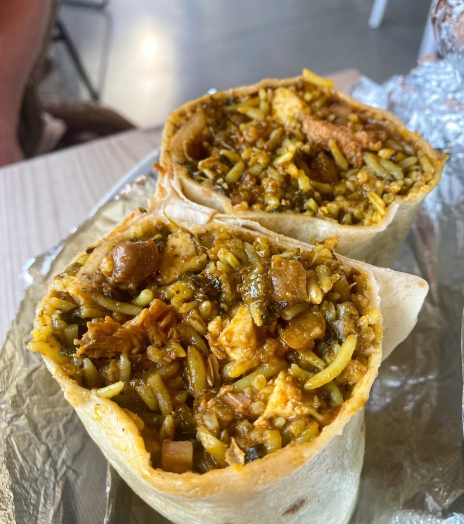 Curry Up Now burrito cut open to reveal a generous filling of curry, rice and meat at Outside Lands 2026.
