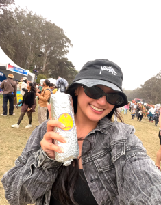 Festivalgoer holding a foil-wrapped Señor Sisig burrito at Outside Lands 2026 in San Francisco.