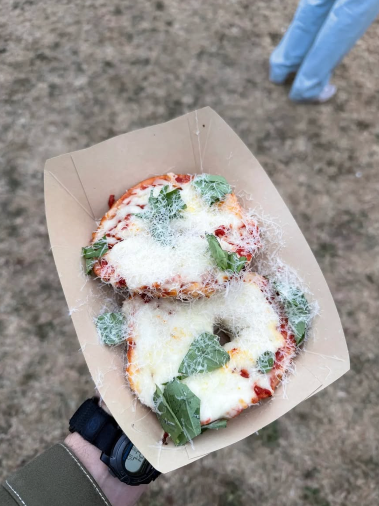 Wise Sons pizza bagels topped with melted cheese, tomato sauce, fresh basil and grated Parmesan at Outside Lands 2026.