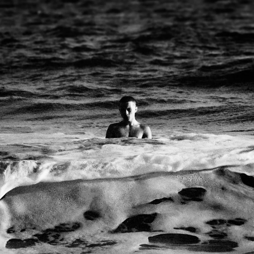 Nettspend standing in ocean waves in the black-and-white music video for “sober”