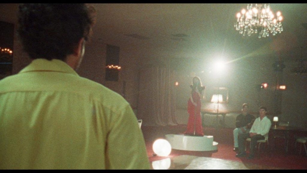 Carly Rae Jepsen performs in a dance hall in the “Don’t Leave Me on the Dance Floor” music video directed by Jeremy O. Harris.