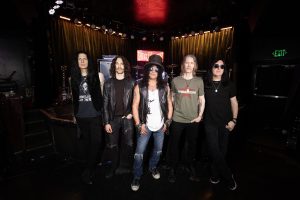 Slash wearing his signature top hat and sunglasses stands with Todd Kerns, Frank Sidoris, Myles Kennedy and Brent Fitz inside the Viper Room in Los Angeles.